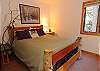 The main floor bedroom with a queen bed