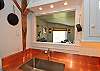 A closeable window into the dining area from the kitchen