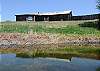 A pond just below the barn