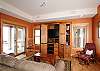 A seating area with a tv is just off the kitchen