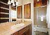 Private bath with dual sinks and a tub/shower combo