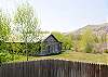 A large fence provides privacy from the road