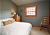 One of the bedrooms with a full size bed