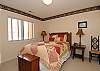 Lower level bedroom with a queen bed