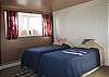 Twin beds on the lower level with a television