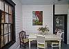 This is the former screened porch that has been fully-enclosed and is now a separate sitting and dining area.
