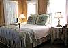 The bedroom features 1 Queen bed and 1 twin bed. There is also a small TV in this bedroom