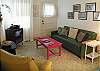 The living room is full of some of the original furniture from the cottage. The floor is the original hardwood with the tile on top from the 1950's. The pillows add just the right touch!