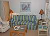 The living room features lots of seating and TV/ DVD with Cable. This room is part of the kitchen and dining area.