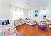 This bedroom features two twin beds