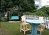The back yard has some really fun outdoor seating. All painted in cottage colors of course!