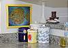 The kitchen is wide open and very bright and cheerful. We also feature art from one of our favorite local artists everywhere in the home- including the kitchen!