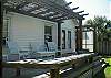 The back yard has a deck with two entrances from the two back bedrooms.  Seating on the deck over looks the fenced in back yard.
