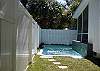 The swimming pool wraps around the side screened porch.