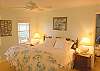 Bedroom 2 features a king size bed, full bathroom with tub and shower and view of the marsh from the windows.