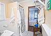 The two bathrooms are "jack and jill" stylee bathrooms.  They are in between each of the bedrooms on both sides of the cottage.