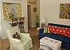 The living room is full of original local art and looks into the kitchen
