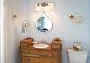 An antique chest of drawers retrofitted with a porcelain basin, make up this Master Bathroom sink. Charming details everywhere!
