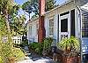 Fence &amp; side yard path and chimney. Side yard entry door.