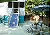 The back deck and pool is accessible from the screened porch back steps.  The pool has lots of seating to relax and enjoy.
