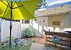 The back yard has seating and unbrella. This area connects to the private pool and has just the right amount of room for sunbathing in the private back yard if you need a break from the beach or for that late afternoon ice tea break!