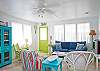 Views of the spacious, open living and dining area. Bright, colorful and fun! This area includes a bar with extra seating; fun place to sit and have a snack!