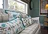 More details of the 2nd floor bedroom. We love the wicker sofa, brass twin bed and beautiful dark wood floors
