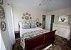 This beautiful and luxurious master bedroom and bath is upstairs.  Lots of soft fluffy pillows are on the queen-size sleigh bed that is made up with high-thread count 100% cotton bedding.  All furnishings are from the new Paula Deen Furniture collection.