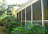 The view of the screened porch from the outside. The entire yard is fenced in and wonderful for dogs and kids!