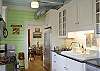 The kitchen is fully equipped and ready to prepare any type meal! There is a gourmet gas stove and oven as well. The large farm sink is yet another vintage find! The kitchen leads to the back porch in the rear and the dining room in the front.