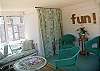 The back porch has wicker seating and overlooks the marsh. The stackable Washer and Dryer is behind the seashell curtain.