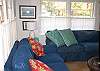 The Living room features two comfy slipcover sofas and TV with cable.