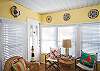 Sunroom; bright and sunny with large windows.