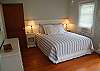 Bedroom 2 also features 1 queen bed, flat screen tv with cable and a door leading out to the back deck.