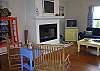 The living room features a fireplace, lots of seating, and is right off the front porch and deck. Full of windows with lots of Natural light.