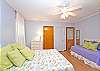 This bright and cheerful bedroom has 1 queen bed and 1 twin bed.