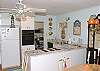 The kitchen is fully stocked with equipment including a dishwasher, microwave, blender and all kitchen tools. The grill is outside on the patio.
