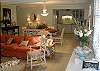 Looking from the front door into the kitchen, living room and dining room area. Note the books available to read- one of our all time favorites- The Prince of Tides.