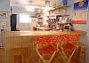 The living room / kitchen/ dining room is a large open family area all blending together. This is the kitchen counter which seats 4