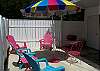 The back yard has seating and unbrella. This area connects to the private pool and has just the right amount of room for sunbathing in the private back yard if you need a break from the beach or for that late afternoon ice tea break!