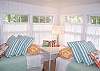 Just makes you want to kick off your shoes and grab a book! This twin bed oasis was once a porch.