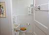 The half bath is off of bedroom 2 and features the original black and white tiles, stained glass window and original sink.