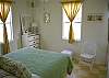 Bedroom 2 has marsh views, a queen bed and half bath.