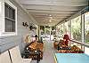The screened porch has lots of outdoor seating including a table for 4-6.