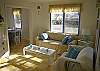 The bright and sunny living room includes the TV/ DVD and CD player