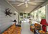 The screened porch has lots of outdoor seating including a table for 4-6.