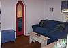 The TV room goes from the master bedrrom and the sun room. The sofa is a double size sofa sleeper . We now have a brand new 37 inch flat panel high def tv and a blue ray/dvd player!