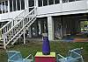 Thhis is a view of the back screened porch, steps leading up to it, the additional back yard seating and the two swings beneath the home.