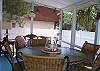 This cottage has two screened porches, one on the front of the cottage and this one, located off the kitchen and dining room. The  pool is located  right outside this porch.