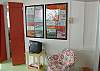 The sun room features lime green floors and the collection of vintage menus from the 1950's tiki bars and tropical restaurants from around the US.